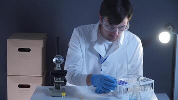 Pathologist working in lab with blood samples. Scientist processing DNA sample in laboratory. Healthcare, blood examination, research of blood. Laboratory worker preparing slide with blood samples. video