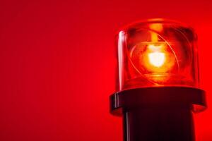Emergency Red Flashing Light Signal Warning, Alert, Attention Isolated on Red Background photo
