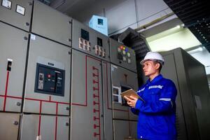 electrical engineer check the operation of the main electrical control panels photo