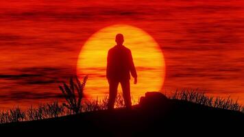 A man stands on a hill with a red sunset in the background video