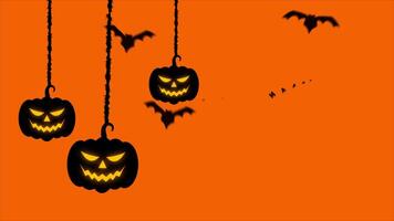 Halloween pumpkins hanging from the ceiling with bats flying around them video