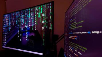 Two monitors with code on them photo