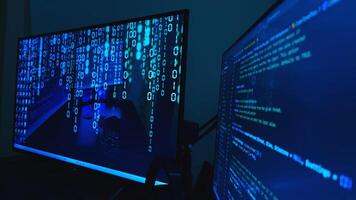 Two monitors with binary code on them photo