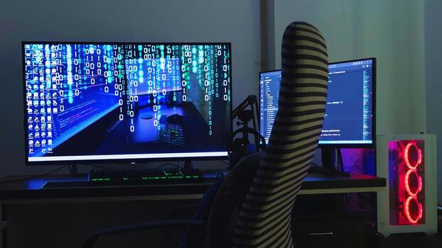 A computer desk with two monitors and a chair photo