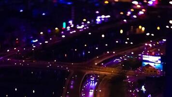 A night timelapse of miniature traffic jam in Ho Chi Minh Vietnam high angle tiltshift panning video