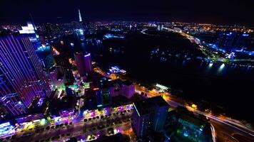 A night timelapse of cityscape near Saigon river in Ho Chi Minh Vietnam high angle wide shot video
