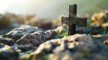 Ancient stone cross on rocky ground with sunlight, serene and spiritual atmosphere, Christian symbol photo