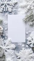 Blank white card surrounded by snowflakes on gray background, perfect for winter holiday invitations photo