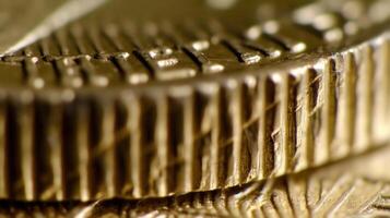 Close-up of coin edge. serrations and detailed texture pattern of golden coins in macro view photo