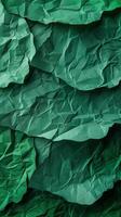 Close-up of wrinkled green paper texture, ideal for scrapbooking and crafting. Top view photo