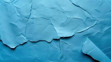 Close-up of wrinkled blue paper texture, ideal for scrapbooking and crafting. Top view photo