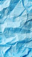 Close-up of wrinkled blue paper texture, ideal for scrapbooking and crafting. Top view photo