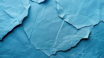 Close-up of wrinkled blue paper texture, ideal for scrapbooking and crafting. Top view photo