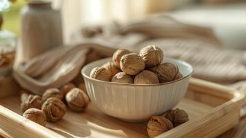 Walnuts in ceramic bowl in wooden tray. Delicate photo for magazine, cookbook, post. Nuts