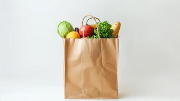Healthy food concept. Paper bag filled with nutritious items on white background photo