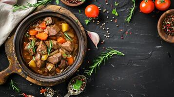Hearty beef stew on rustic table. Home-cooked meal. Tender beef, potatoes, carrots, herbs in rich sauce photo