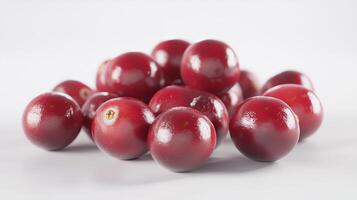 A detailed and realistic close up of fresh, succulent cranberries set against a pure white backdrop. photo