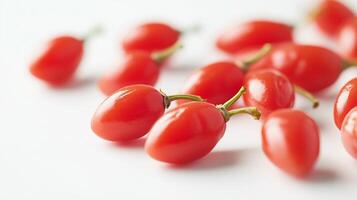 succulent goji berries on a bright white background. The image focuses on the detailed and realistic photo