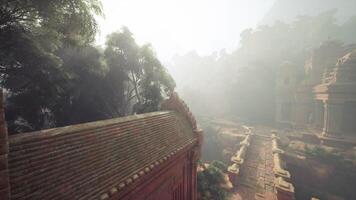 Ancient temple ruins shrouded in Vietnams jungle morning fog video
