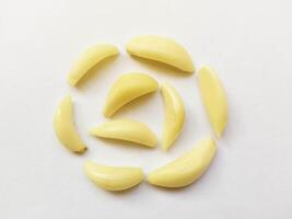 Peeled cloves of garlic isolated on white background - Lehsan Cloves in a circle shape photo