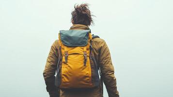 A person wearing a backpack, looking away against a neutral background photo