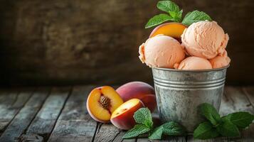 Peach ice cream in rustic metal bucket with fresh peaches photo