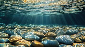 Smooth pebbles resting at the bottom of clear water, enhanced by reflections photo