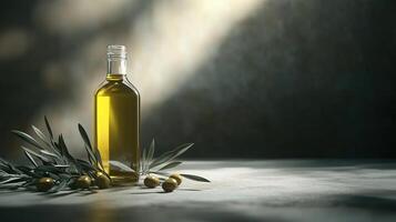 A bottle of olive oil is on a table with a bunch of olive leaves photo