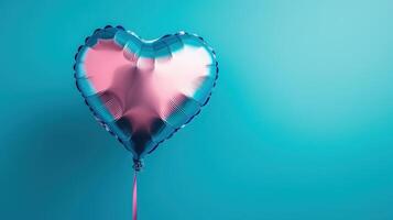 Pink and blue heart shaped balloon on blue background photo