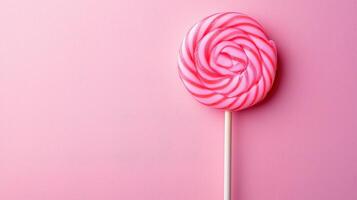 Lollipop on one stick on one pink boneckground photo