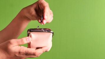 A person holding a small purse with a coin in it video