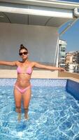 A person is enjoying a refreshing swim in a luxurious rooftop pool on a sunny day video