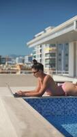 Embracing Remote Work While Enjoying Relaxation and Sunshine by the Poolside in Summer video