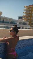 Enjoying a peaceful and relaxing time by the beautiful pool while wearing a stylish pink bikini video