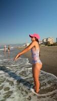 A Joyful Day at the Beach A Child Embracing the Waves with Delightful Happiness video