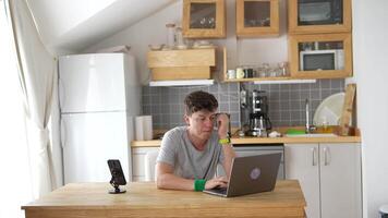A Young Person Who is Focused and Working on a Laptop While at Home in a Comfortable Environment video