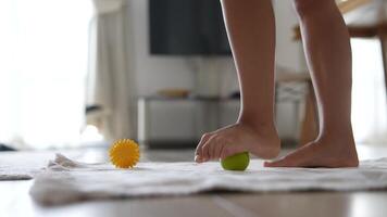 A Young Child Joyfully Engaged in Play with Brightly Colored Balls on a Soft Surface video