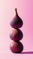 A stack of fig fruit balancing on top with solid background photo