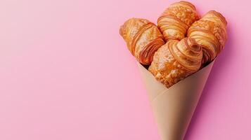 Croissant wrapped on brown paper cone wrapped copy space background photo