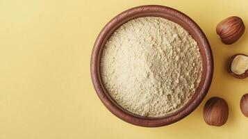 Chesnut flour on brown wooden bowl and some nuts for baking, gluten free copy space photo