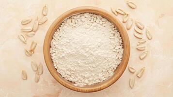 Sunflower flour on brown wooden bowl and some seeds for baking, gluten free copy space photo