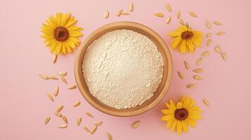 Sunflower flour on brown wooden bowl and some seeds for baking, gluten free copy space photo