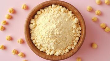 Chickpea flour on brown wooden bowl and some Chickpeas for baking, gluten free copy space photo