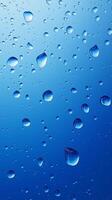 Waterdrop bubble splashing rounded on blue blurred background photo