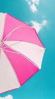 Umbrella pink and white beach for sunburn protection and blue sky bottom view photo