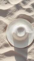Top of view straw hat on white sand beach holiday summer destination theme photo