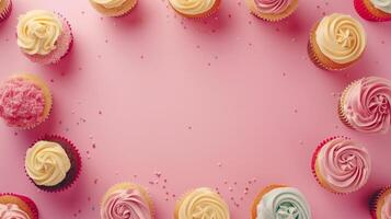 Circular arrangement sweet cupcake topping cream copy space black in center pink background photo