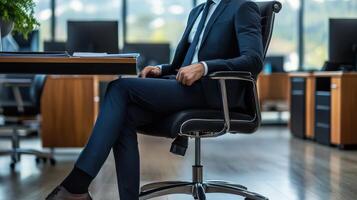 A man in a suit sitting on an office chair photo