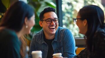 Three people laughing at a table photo