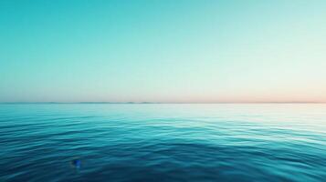 A blue ocean with a small boat floating in it photo
